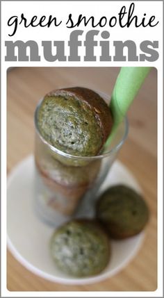 a cup filled with green stuff on top of a white plate