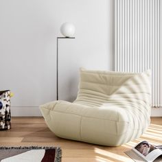 a white chair sitting on top of a hard wood floor