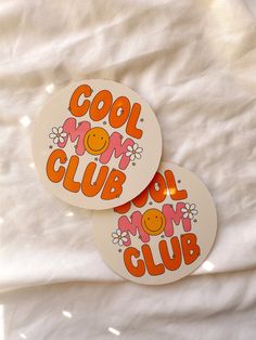 two stickers with the words cool mom club written in orange and pink on them