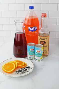 orange slices, syrup, and other ingredients on a white counter top with a plate