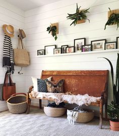 a living room filled with lots of plants and decor