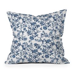 a blue and white pillow with flowers on it