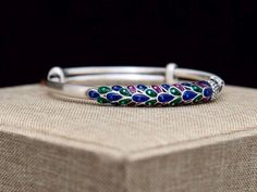 "Beautiful Enamel Peacock bangle bracelet for the upcoming season , made with 999 fine silver and multi colors of enamel , unique and stylish . Width: 3/10 \" ( 6mm ) Diameter: 60mm Adjustable Weight : 31 grams ♥️ For other fine silver bracelets , click here : https://www.etsy.com/shop/tibicollection?section_id=24787065 Return to my shop's home page, click here : https://www.etsy.com/shop/tibicollection" Peacock Design Bracelets For Festivals And Gifts, Peacock Design Bangle Bracelet Gift, Solid Silver Bracelets, Unique Gold Jewelry Designs, Peacock Jewelry, Statement Bracelet, 925 Silver Jewelry, Gold Jewellery Design, Silver Pieces