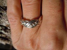 With the top bands doubled, and open design, this six-band puzzle ring has a very Celtic feel to it.  It is very easy to assemble. It goes together like a four-band ring.  The listing is for a ladies' sterling ring, but we are happy to make it in gold, platinum, or any combinations of metals. The six-band puzzle ring is still fairly easy to assemble, and each band is stamped with a number to make it easier, especially with the illustrated instructions that come with each ring. When placing your order, please note the ring size you would like.  The dimensions are 8.50mm on the top and 5.50mm on the bottom. Weights: Sterling 6.22 grams 10K 5.60 grams 14K 7.78 grams 18K 9.27 grams Platinum 12.81 grams *Please note that weights are approximate and based on a size 7 While puzzle rings are our s Puzzle Rings, Puzzle Ring, Illustrated Instructions, Top Band, Open Design, Gold Platinum, Sterling Ring, Band Ring, Band Rings