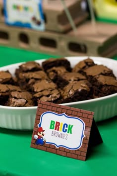 there is a plate of brownies and a sign on the table that says brick