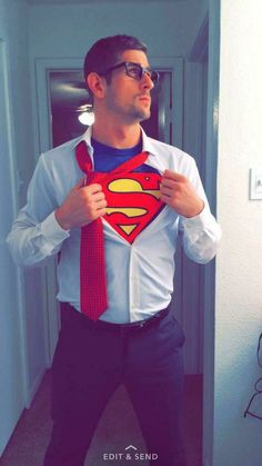 a man wearing a superman shirt and tie