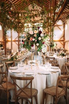 the tables are set with white tablecloths and floral centerpieces for an elegant wedding reception