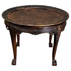 an ornately decorated wooden table with metal trimmings and carvings on the top