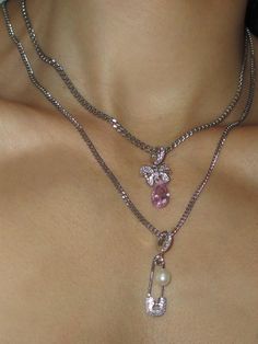 Chain in Stainless Steel Pendant in 925 Sterling Silver with Pink Cubic Zirconia Chain Length: 15, 18 or 20 Inches Model wears 15 Inches Handmade in Los Angeles - please allow 1-5 business days for this item to ship THE PINK BOW CHAIN features an adorable pink bow charm in 925 sterling silver on a stainless steel chain. Styled here with the PIN THROUGH MY PEARL CHAIN Pink Chain Jewelry For Formal Occasions, Formal Pink Jewelry With Chain, Formal Pink Chain Jewelry, Formal Pink Jewelry With Chain Detail, Pink Metal Chain Necklace With Adjustable Chain, Elegant Sterling Silver Necklace With Bow, Pink Bow Necklace, Pink Gold-plated Charm Necklace With Adjustable Chain, Nickel-free Pink Sterling Silver Charm Necklaces