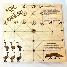 a wooden board game with animals and numbers on the front, along with words that read fox and geese