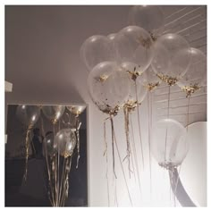 some balloons are hanging from the ceiling in a room