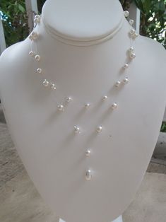 "Bridal Illusion Necklace ~ This lovely 2 strand invisible necklace is made with a white Swarovski tear pearl paired with smaller 5mm and 6mm round Swarovski pearls. Created on illusion wire, the crystals and pearls seem to float on your neck! Makes wonderful bridal jewelry or bridesmaids gift. The necklace measures approximately 15\" along the shorter strand and 17\" on the longer. An extender chain adds 2\" of length. 15\" is shorter than typical necklaces, which are 16.5\", so please contact