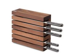 four knives are stacked on top of each other in the same holder, with one knife sticking out of it's side