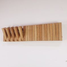 four wooden toothbrushes lined up on top of each other in front of a white background