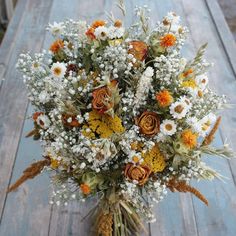 a bouquet of flowers sitting on top of a wooden table