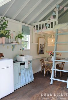 a small kitchen with a ladder to the ceiling