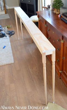 a wooden table sitting on top of a hard wood floor