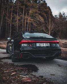 the rear end of a black sports car