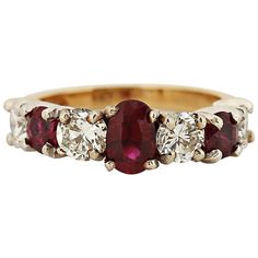 This timeless ring is a beautiful balance of red and white, showcasing a radiant oval ruby at its center. The ruby is flanked by alternating round diamonds and rubies, creating a striking contrast. Set in 14 karat white and yellow gold, the ring features three rubies totaling approximately 1.10 carats and four round brilliant diamonds, G color, VS clarity, totaling approximately 1 carat. Currently a size 6.5, it can be resized. Circa 2000. Center Stone: Oval ruby Weight: Approximately 1.10 carat Oval Red Ruby Ring With Three Stones, Luxury Oval Three-stone Ruby Ring, Classic Red Oval Diamond Ring, Timeless Red Ruby Ring For Anniversary, Oval Multi-stone Ruby Ring In White Gold, Classic Ruby Diamond Multi-stone Ring, Heirloom Red Oval Diamond Ring, Classic Multi-stone Round Ruby Ring, Classic White Gold Multi-stone Ruby Ring