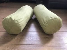 two green bean bags sitting on top of a wooden floor