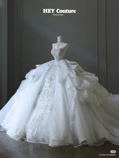 a white wedding dress on display with the words hey couture written above it