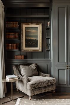 a living room filled with furniture and bookshelves next to a painting on the wall