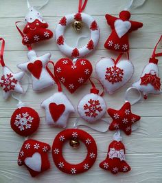 red and white ornaments are arranged on a table