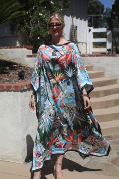 Beautiful tropical print designer silk kaftan for your summer enjoyment.  Casual or dressy you will enjoy this beauty for any occasion. One size.  Fits small to extra large sizes.  The width is 51 inches, edge to edge, 102 around the body.  The side seams are 6 inches from the edge.  The length is 50 inches.  Hand or machine wash on a short, gentle cycle. Tropical Green Kaftan For Beach Cover-up, Green Dress With Floral Print And Kimono Sleeves, Green Floral Print Long Sleeve Kaftan, Green Bohemian Kaftan With Floral Print, Vacation Green Kaftan With Floral Print, Green Tropical Dress With Vibrant Print, Tropical Green Dress With Vibrant Print, Green Tunic Kimono For Vacation, Green Floral Print Tunic Kaftan