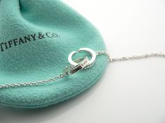 Offered for sale is a gorgeous and classic Tiffany & Co. Sterling Silver 1837 Interlocking Multi Circles necklace. The piece is crafted from bright and substantial Tiffany silver. Great and unique way to say "I love you" or "I love me :)!". It is a wonderful necklace that fits a lifestyle on the go -- the necklace can be worn to almost any occasion! It is simple, elegant, and classic all rolled into one necklace. Imagine the piece with your professional office attire ... Now imagine it with Interlocking Circle Necklace, I Love Me, Professional Office, Gift Pouch, Circle Necklace, Say I Love You, Necklace Chain, Love Me, Tiffany & Co.