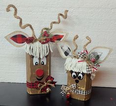 two christmas decorations made out of brown paper bags with reindeer heads and noses on them