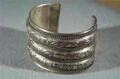 I am offering you this wonderful and very unique and ornate silver plated bangle extra wide cuff style bracelet with amazing detailed designs and very domed. Just look at the fabulous detail in this very bold, wide, domed raised relief , etching, and braid work adorning the entire circumference of this marvelous cuff bangle bracelet. This is a very unique design, having so many ornate elements to it, with of very thick and heavy cuff / bangle style bracelet What a fabulous combination of element Luxury Vintage Cuff Bracelet With Oxidized Finish, Luxury Traditional Silver Cuff Bracelet, Luxury Silver Victorian Cuff Bracelet, Luxury Silver Bohemian Bangle, Luxury Handmade Antique Silver Bracelets, Thick Silver Jewelry, Western Jewellery, Metal Cuff Bracelet, Vintage Bangles