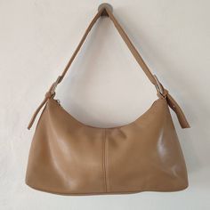 "00s Y2K Vintage BHS Tan Camel Brown Faux Leather PVC Handbag/Shoulder Bag Measures:  12\" width 6\" length  3\" depth (at base) 25\" strap length Material/Fabric: Faux leather pvc vinyl, with a polyester lining Fastening: Zipper closure. Features: Adjustable shoulder strap  Offered in good condition with minor signs of wear as pictured." Y2k Leather Bag With Zipper Closure, Y2k Rectangular Shoulder Bag With Adjustable Strap, Y2k Satchel With Adjustable Strap, Y2k Satchel Shoulder Bag With Adjustable Strap, Y2k Leather Bag For Daily Use, Y2k Style Leather Bag For Daily Use, Y2k Rectangular Travel Shoulder Bag, Y2k Style Rectangular Travel Shoulder Bag, Y2k Rectangular Shoulder Bag For Travel