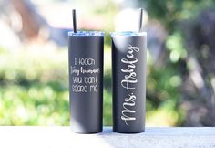 two black tumblers sitting on top of a table