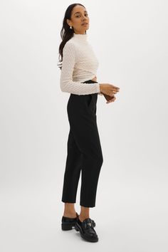 Unleash your fashion creativity with the versatile Velma Crossover Long Sleeve Top. With its unique cloqué texture and asymmetrical crossover detail, this top is a true standout. Wear it with the crossover in front, or turn it around and wear it with the crossover in the back for an intriguing twist.