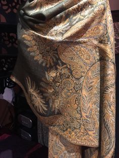 Deep olive green and beige Vintage styled wrap 28 X 70 inch Nice brocade paisley Very soft silk blend Styled from ancient Jamawar Indian motifs These are replicated from vintage shawl collections by my own company We may have larger quantities available for weddings, bridesmaids, or wholesale orders. Please inquire. All shipped free in the US Please check out our THOUSANDS of great reviews Green Pashmina Shawl In Traditional Drape, Elegant Green Pashmina Shawl, Elegant Green Festive Pashmina Shawl, Green Jamawar Shawl With Traditional Drape, Elegant Green Shawl With Zari Work, Gold Pashmina Shawl, Gold Bohemian Pashmina Shawl, Brown Pashmina Shawl With Paisley Print, Brown Paisley Pashmina Shawl