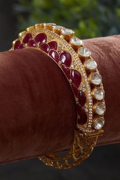 18kt gold plated kada with red utrai on both sides and polki embellishment. - Aza Fashions Elegant Red Bracelet With Stone Work, Elegant Red Bracelets With Stone Work, Red Stone Work Bangle For Diwali, Diwali Red Stone Work Bangle, Festive Yellow Gold Bangle With 17 Jewels, Kundan Meenakari Bangle For Reception, Reception Kundan Bangle With Meenakari, Meenakari Kundan Bangle For Reception, Reception Meenakari Kundan Bangle