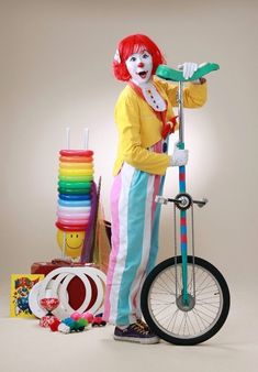 a clown is standing next to a bicycle