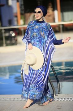 Ready to meet a modest elegance with a feminine look of purple, blue, floral patterns, and soft fabric? Our Burkini pareo caftan is designed to create a great combination with other burkini sets with its vivid and trendy look. Thanks to its soft and light texture, it will make you look perfect and reinforces your elegance when you are around the pool. Hey, especially Lycra Fabric Blue is a great option to combine with Phoenix Burkini! Long Sleeve Abaya For Eid Beach Occasion, Long Sleeve Abaya For Beach Eid, Long Sleeve Abaya For Beach And Eid, Blue Long Sleeve Swimwear For Beach Cover-up, Summer Beach Abaya In Free Size, Elegant Beach Abaya For Spring, Elegant Spring Beach Abaya, Elegant Long Sleeve Swimwear For The Beach, Beach Abaya Free Size