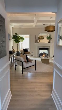 a living room filled with furniture and a fire place in the middle of a room