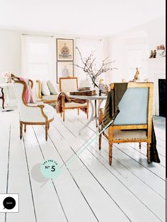 a living room filled with lots of furniture and a fire place in the middle of it