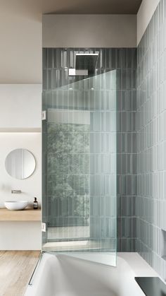 a white bath tub sitting inside of a bathroom next to a sink and mirror on the wall