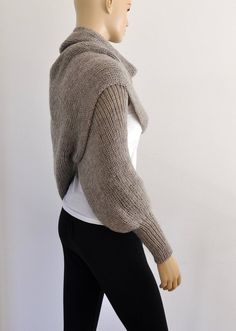 a mannequin wearing a sweater and leggings with her hands in her pockets