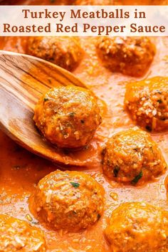 meatballs in tomato sauce being stirred with a wooden spoon and placed on top of them