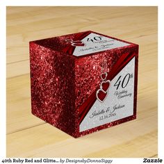 a red glittered box with the number 40 on it and a heart hanging from the front