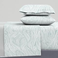 three pillows are stacked on top of each other