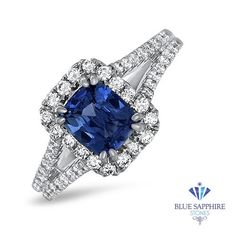 a blue sapphire and diamond ring set in white gold with diamonds around the center stone