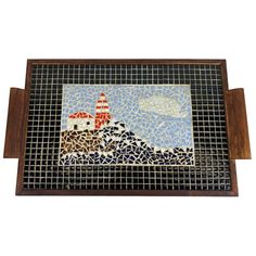 a mosaic tile tray with a lighthouse on it