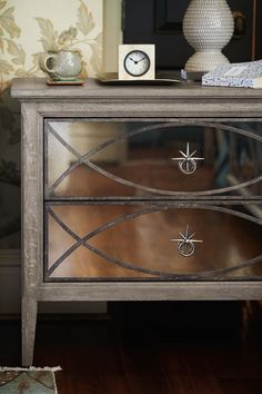 a mirrored cabinet with an ornate design on it