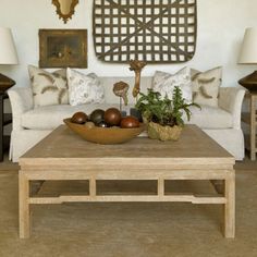 a living room filled with furniture and a bowl of fruit on top of a coffee table