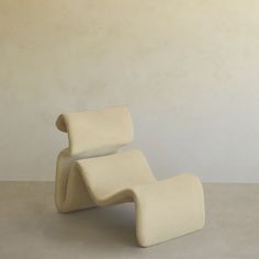 a white chair sitting on top of a cement floor